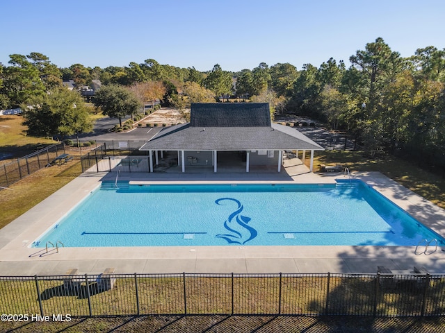 community pool featuring a patio and fence