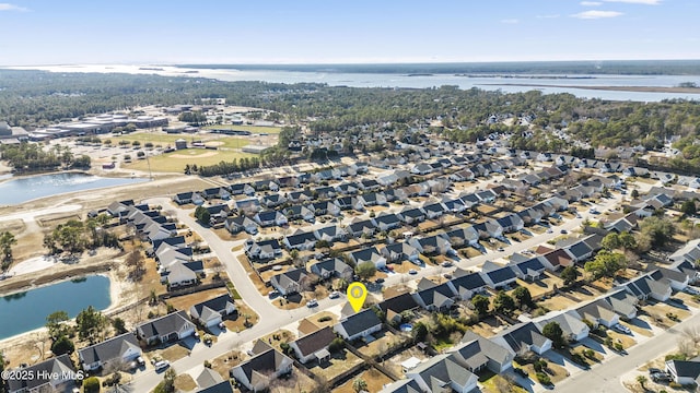 drone / aerial view with a residential view and a water view