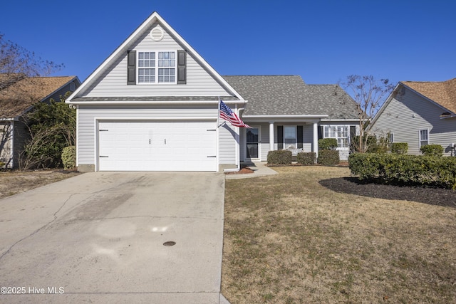 traditional-style house featuring a front lawn, concrete driveway, and a garage