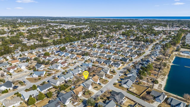 bird's eye view featuring a water view and a residential view