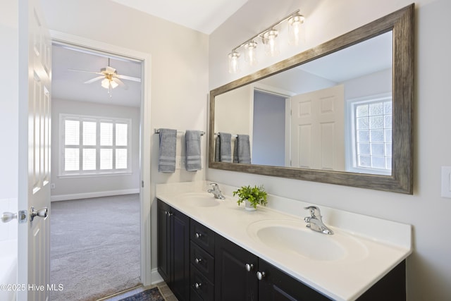 bathroom featuring vanity, ceiling fan, and a healthy amount of sunlight