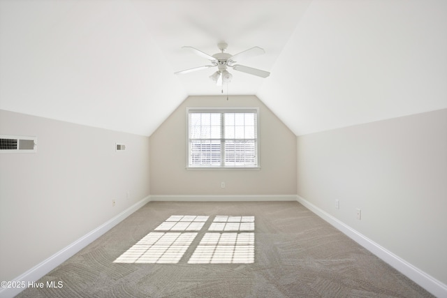 bonus room with light carpet, vaulted ceiling, and ceiling fan