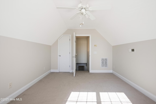 bonus room with ceiling fan, light colored carpet, and lofted ceiling