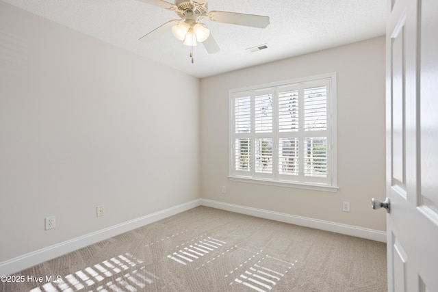 carpeted empty room featuring a textured ceiling and ceiling fan