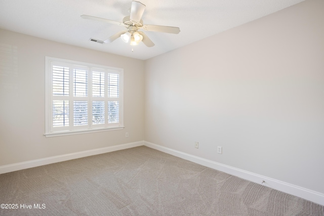 unfurnished room featuring ceiling fan and carpet flooring