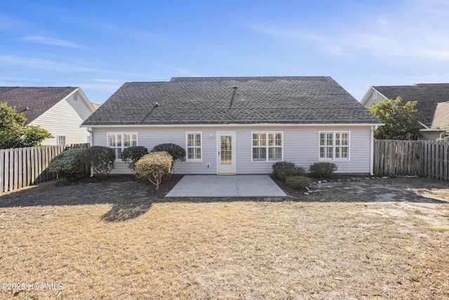 back of property featuring a patio area, a fenced backyard, and a shingled roof