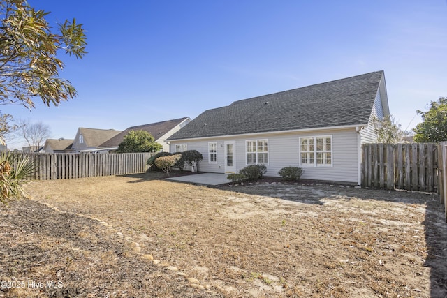 back of house with a patio area, a shingled roof, and a fenced backyard