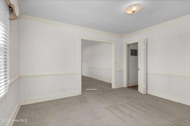 carpeted spare room with crown molding