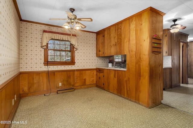 kitchen featuring ceiling fan and crown molding