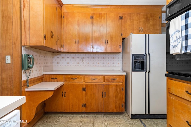 kitchen featuring backsplash and white fridge with ice dispenser