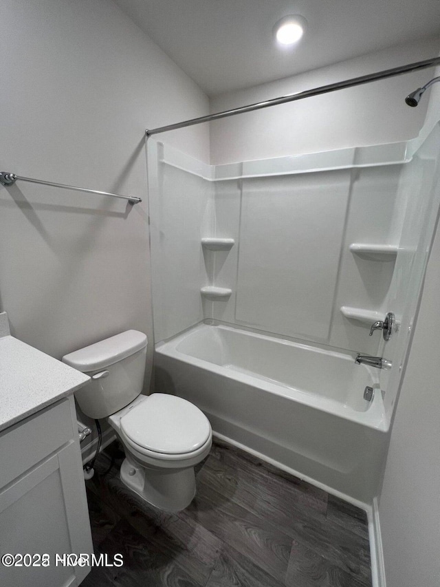 full bathroom with shower / tub combination, vanity, toilet, and hardwood / wood-style floors