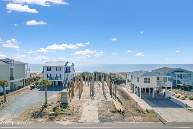 view of front of property featuring a carport, a water view, and driveway