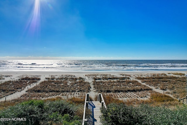 aerial view featuring a water view and a beach view