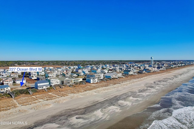 birds eye view of property with a water view and a view of the beach