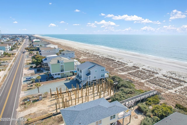 aerial view with a water view and a view of the beach