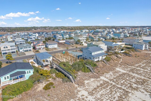 bird's eye view featuring a beach view and a water view