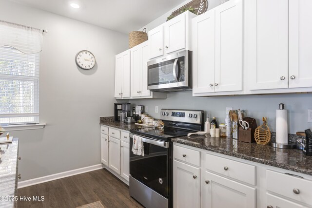 interior space featuring toilet, hardwood / wood-style floors, vanity, and a notable chandelier