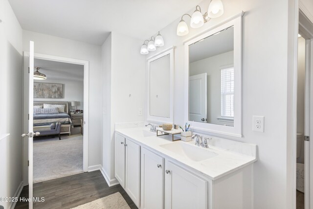 kitchen featuring dark wood-type flooring, white cabinetry, stainless steel appliances, and dark stone countertops