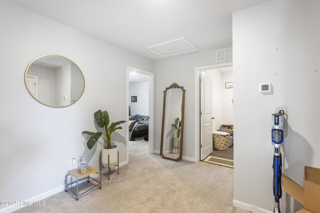 hallway featuring light carpet