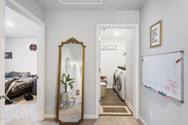 laundry room featuring separate washer and dryer and hardwood / wood-style flooring