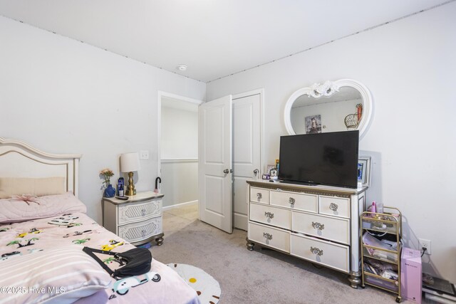 bedroom featuring light carpet