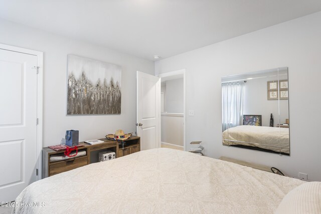 bedroom featuring light carpet