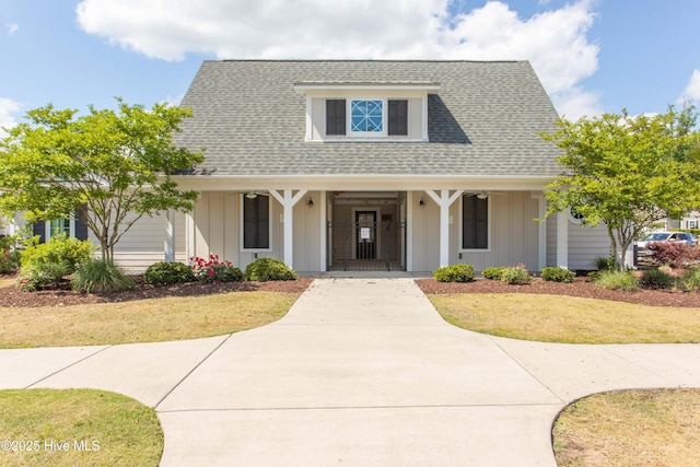 view of front of property with a front yard and a porch