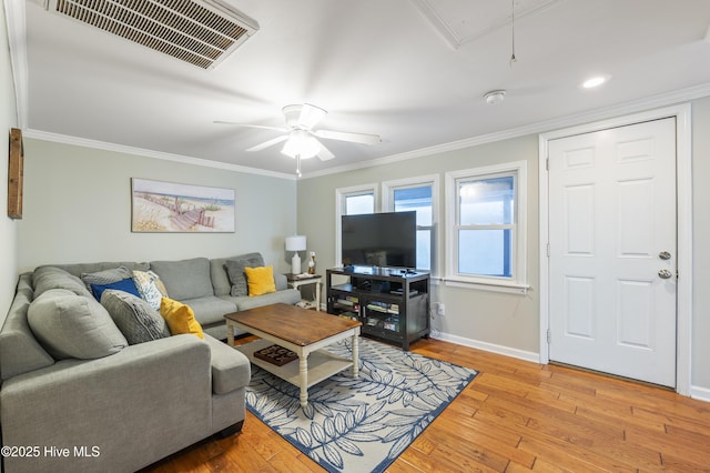 living room with light hardwood / wood-style floors, ornamental molding, and ceiling fan