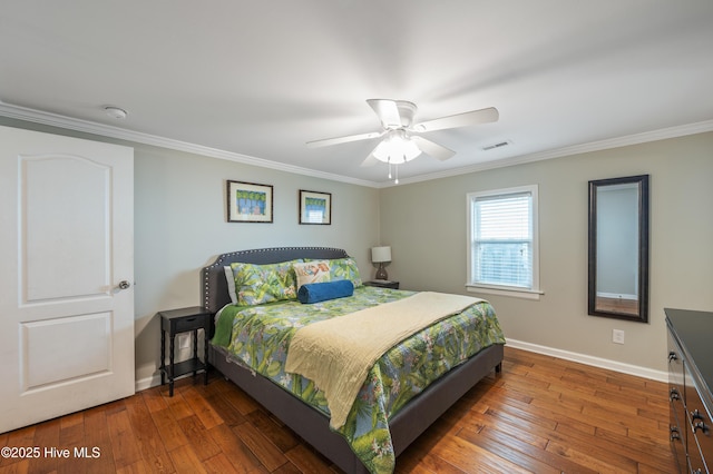 bedroom featuring ceiling fan, dark hardwood / wood-style flooring, and crown molding