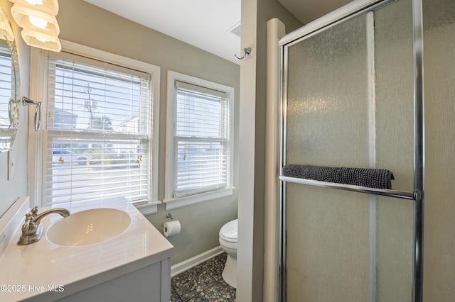 bathroom with an enclosed shower, vanity, tile patterned floors, and toilet