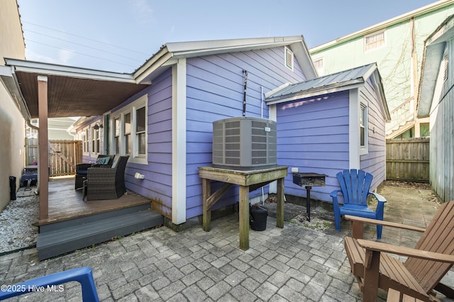 back of property featuring central AC, a deck, and a patio