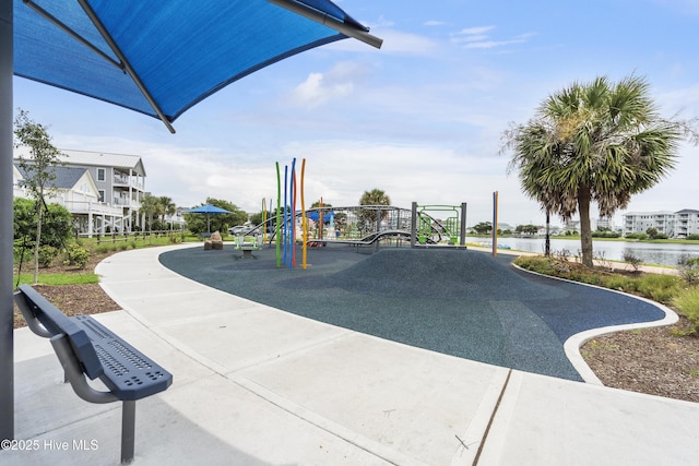 view of community featuring a playground and a water view