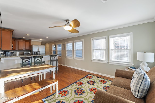 living room with ceiling fan, dark hardwood / wood-style floors, and crown molding