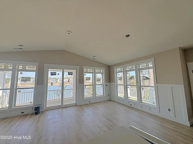 unfurnished sunroom with vaulted ceiling