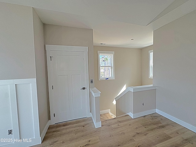 entryway with baseboards and wood finished floors