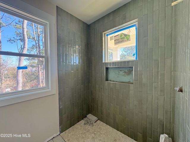 bathroom featuring a tile shower