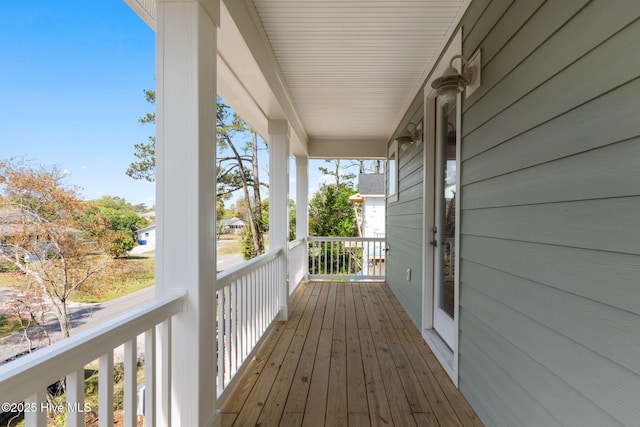 wooden terrace with a porch