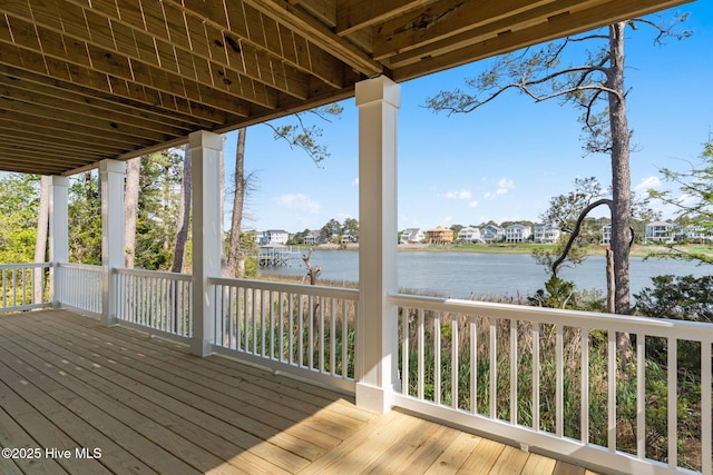 wooden terrace featuring a residential view and a water view