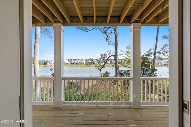wooden terrace featuring a water view