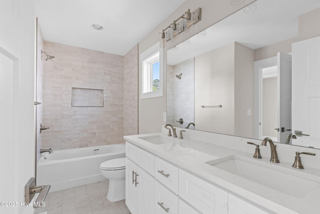 full bathroom with double vanity, toilet,  shower combination, and a sink