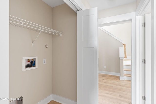 laundry room with laundry area, light wood-type flooring, baseboards, and hookup for a washing machine