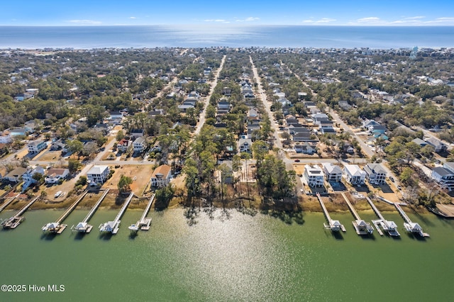 birds eye view of property with a water view and a residential view