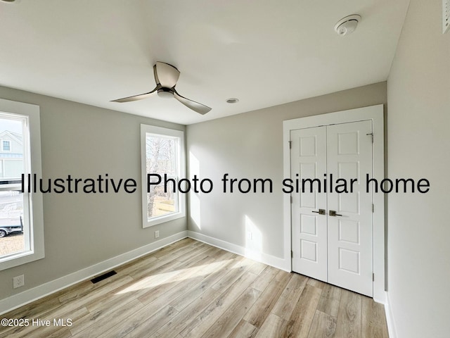 unfurnished bedroom featuring baseboards, a closet, and light wood-style floors