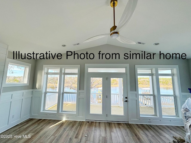 doorway featuring vaulted ceiling, wood finished floors, and visible vents