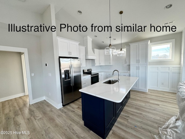 kitchen featuring a sink, white cabinetry, visible vents, appliances with stainless steel finishes, and custom range hood