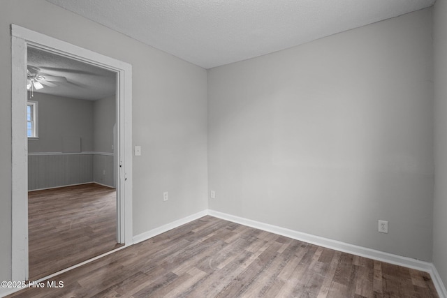 unfurnished room featuring a textured ceiling, ceiling fan, and hardwood / wood-style floors