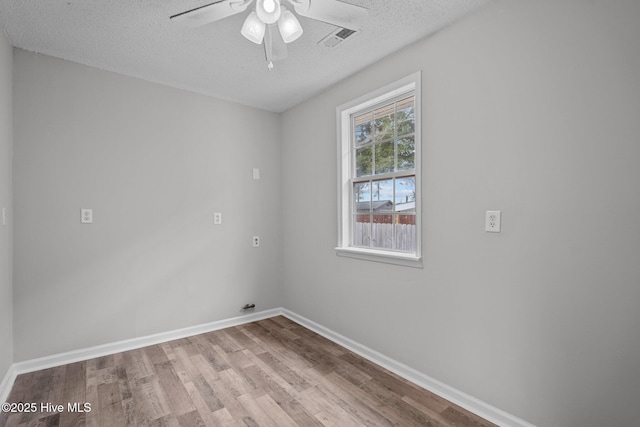 empty room featuring ceiling fan, a textured ceiling, and light hardwood / wood-style floors