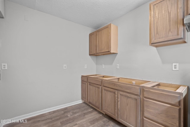 kitchen featuring a textured ceiling and wood-type flooring