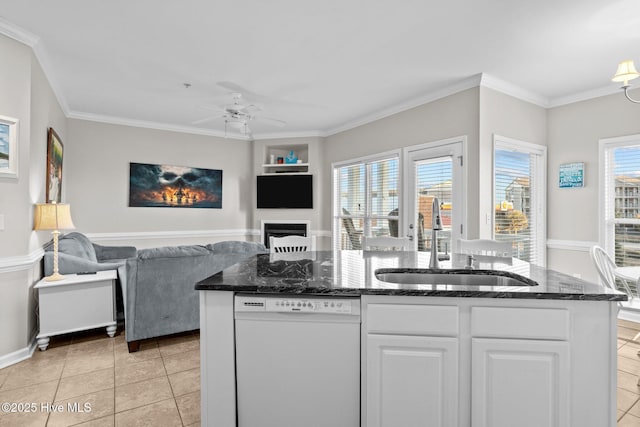 kitchen featuring built in features, dishwasher, sink, white cabinets, and light tile patterned floors