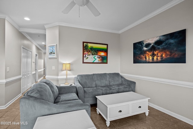 living room with dark tile patterned floors, ornamental molding, and ceiling fan